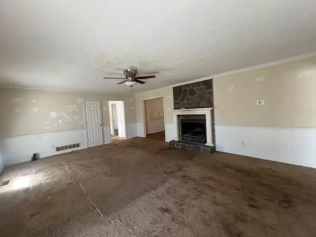 a view of empty room with window and fireplace