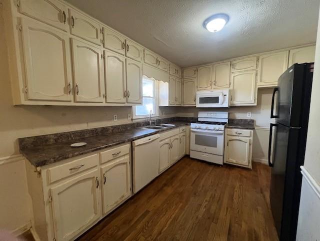 60 Timber Mill Circle Carrollton, GA 30116 - Photo 4 of 14 a kitchen with white cabinets and white appliances