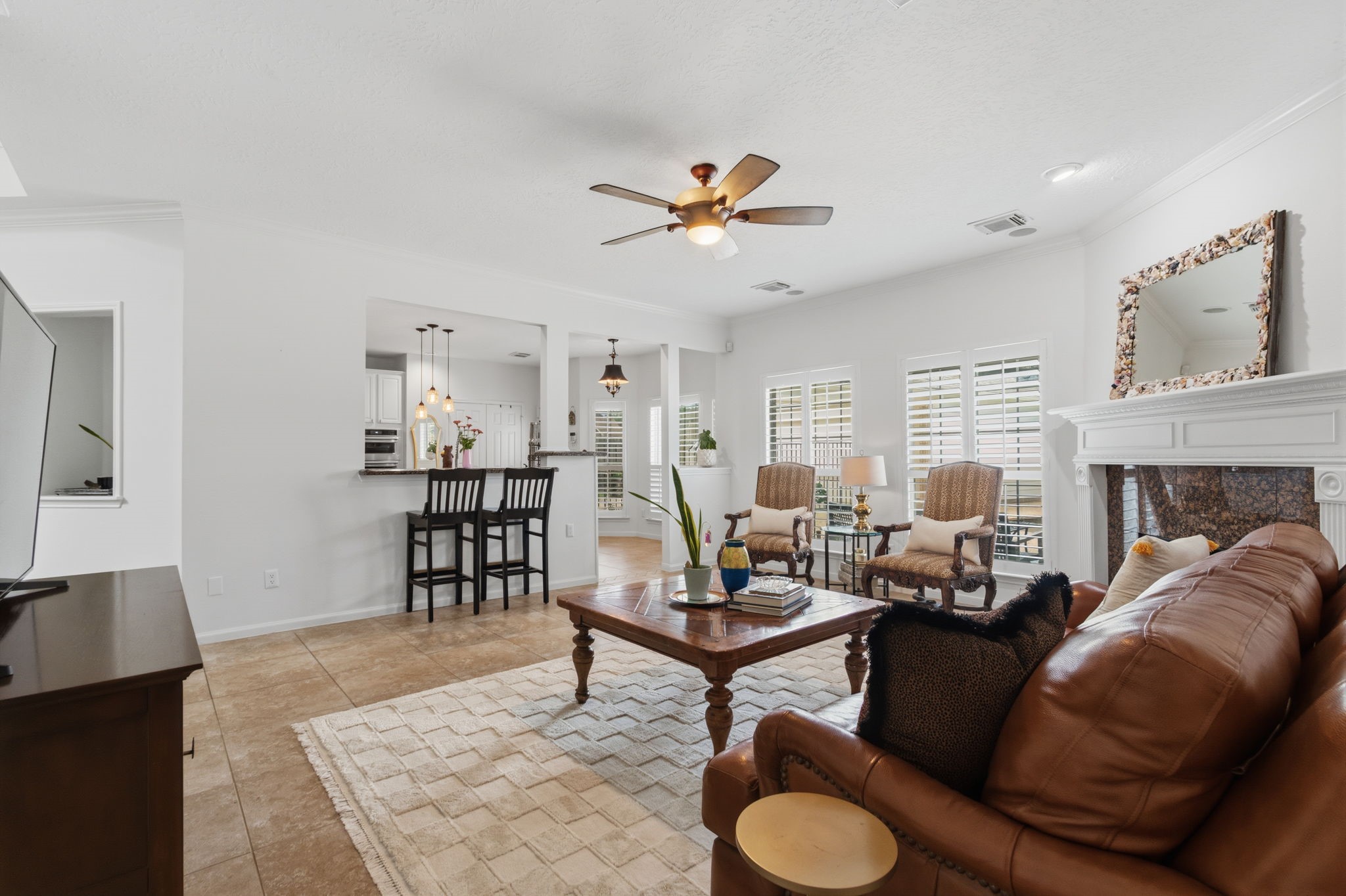 8419 Marchelle Lane Spring, TX 77379 - Photo 6 of 42 a living room with furniture a fireplace and a flat screen tv