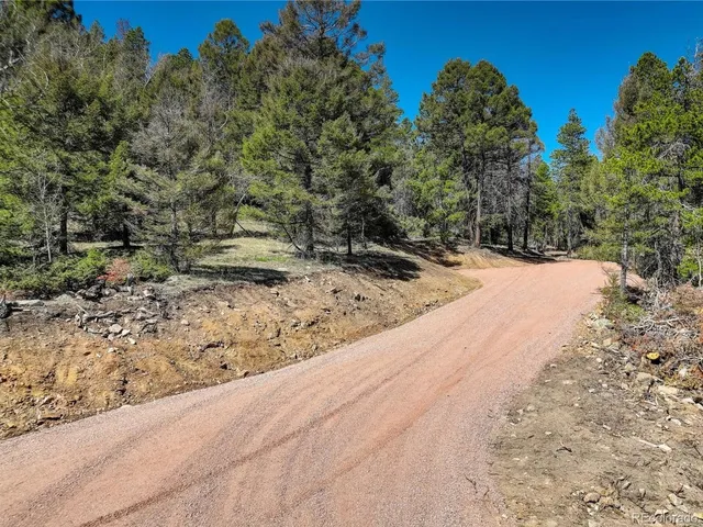 a view of a yard covered with snow in front of house