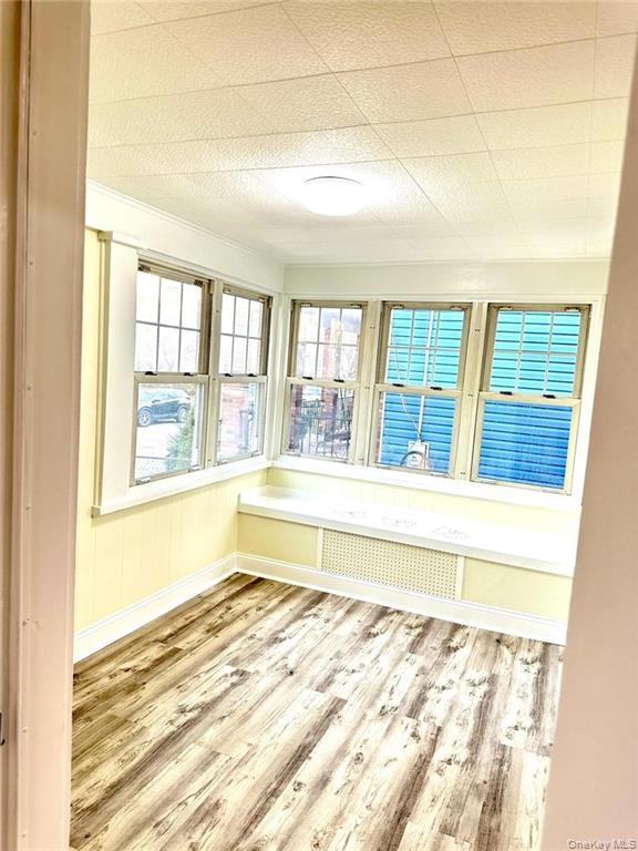 48 Lincoln Street New Rochelle, NY 10801 - Photo 2 of 9 Unfurnished sunroom featuring radiator heating unit