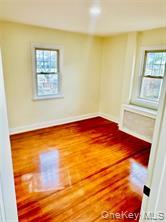 48 Lincoln Street New Rochelle, NY 10801 - Photo 4 of 9 Empty room with wood finished floors and baseboards