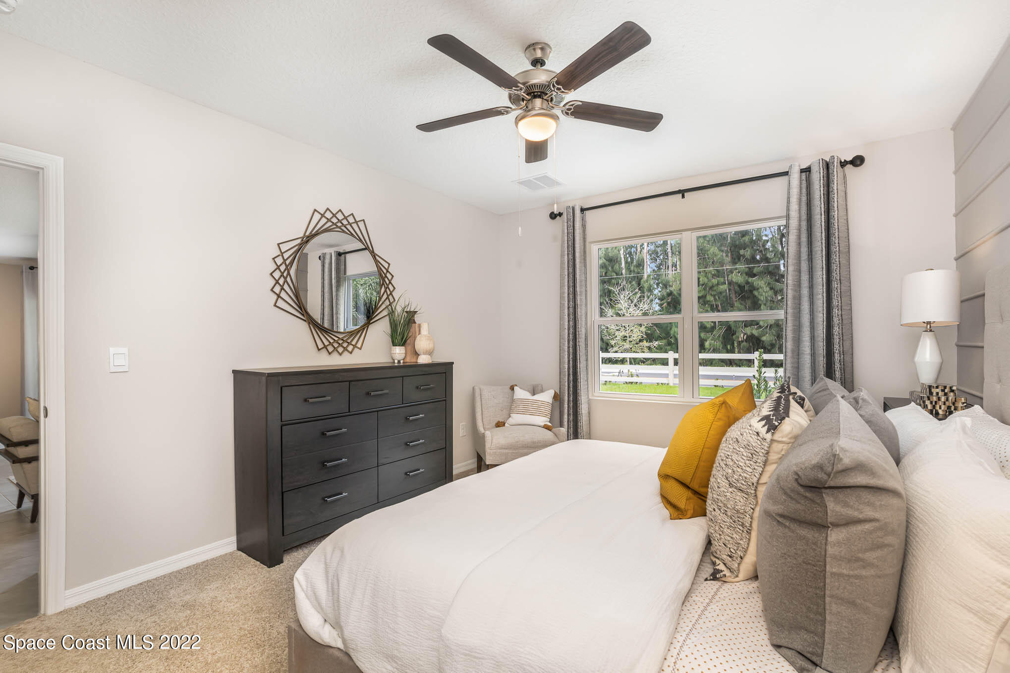 1058 Trinity Street Rockledge, FL 32955 - Photo 17 of 30 a bed sitting in a bedroom next to a window