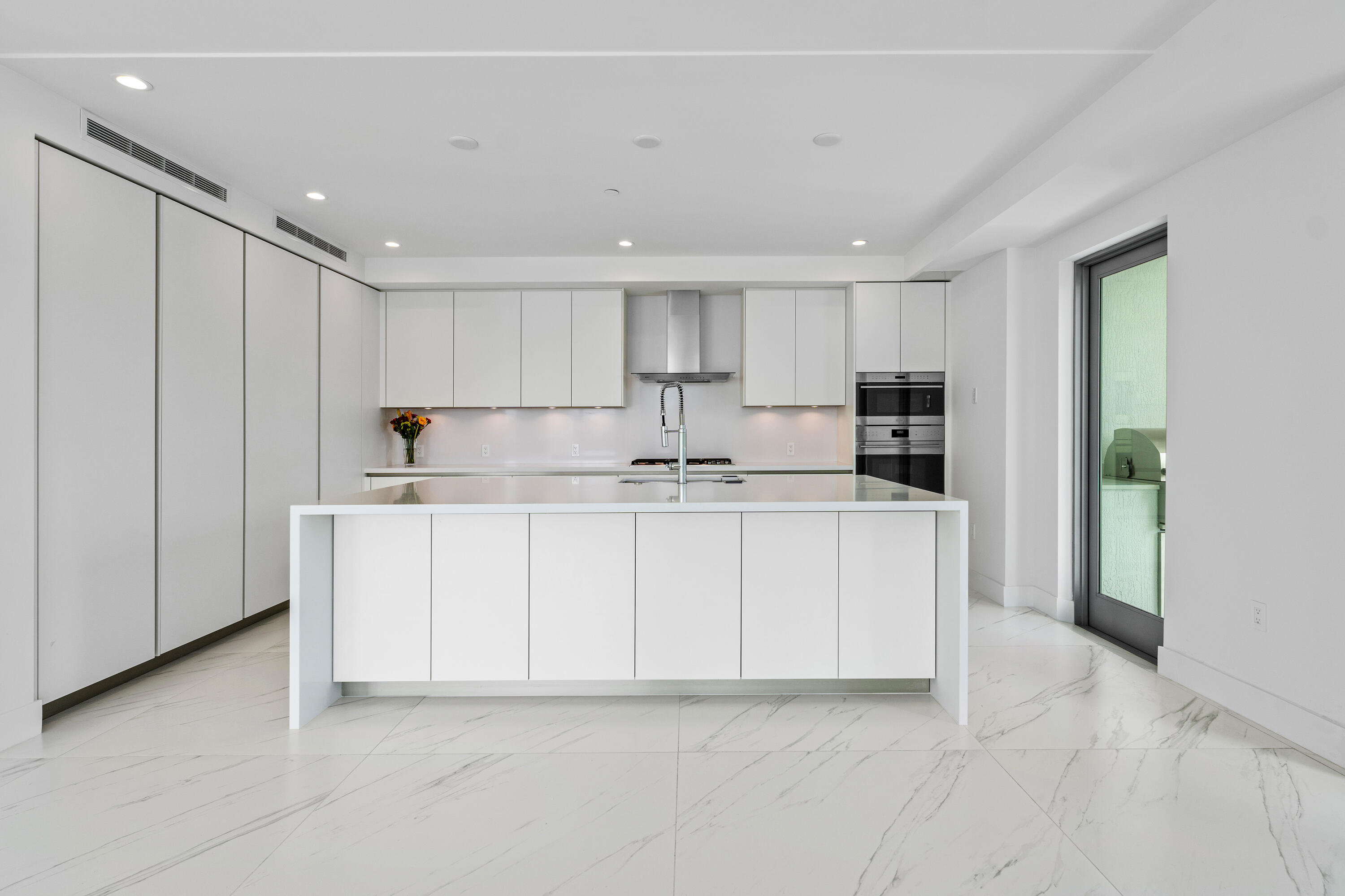 495 East Royal Palm Road, Unit 402 Boca Raton, FL 33432 - Photo 12 of 63 a kitchen with granite countertop white cabinets and stainless steel appliances