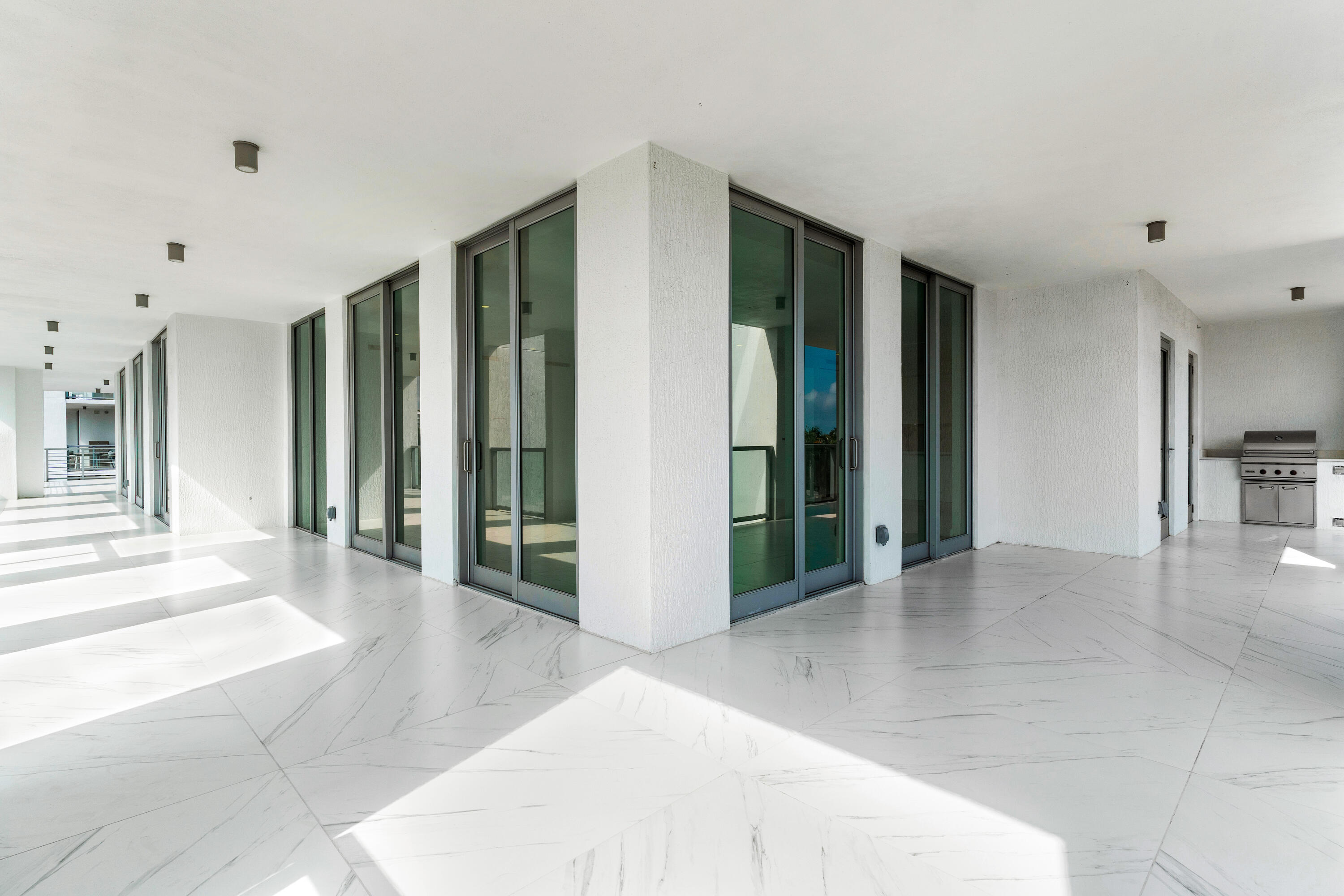 495 East Royal Palm Road, Unit 402 Boca Raton, FL 33432 - Photo 35 of 63 a view of a hallway with wooden floor and a living room