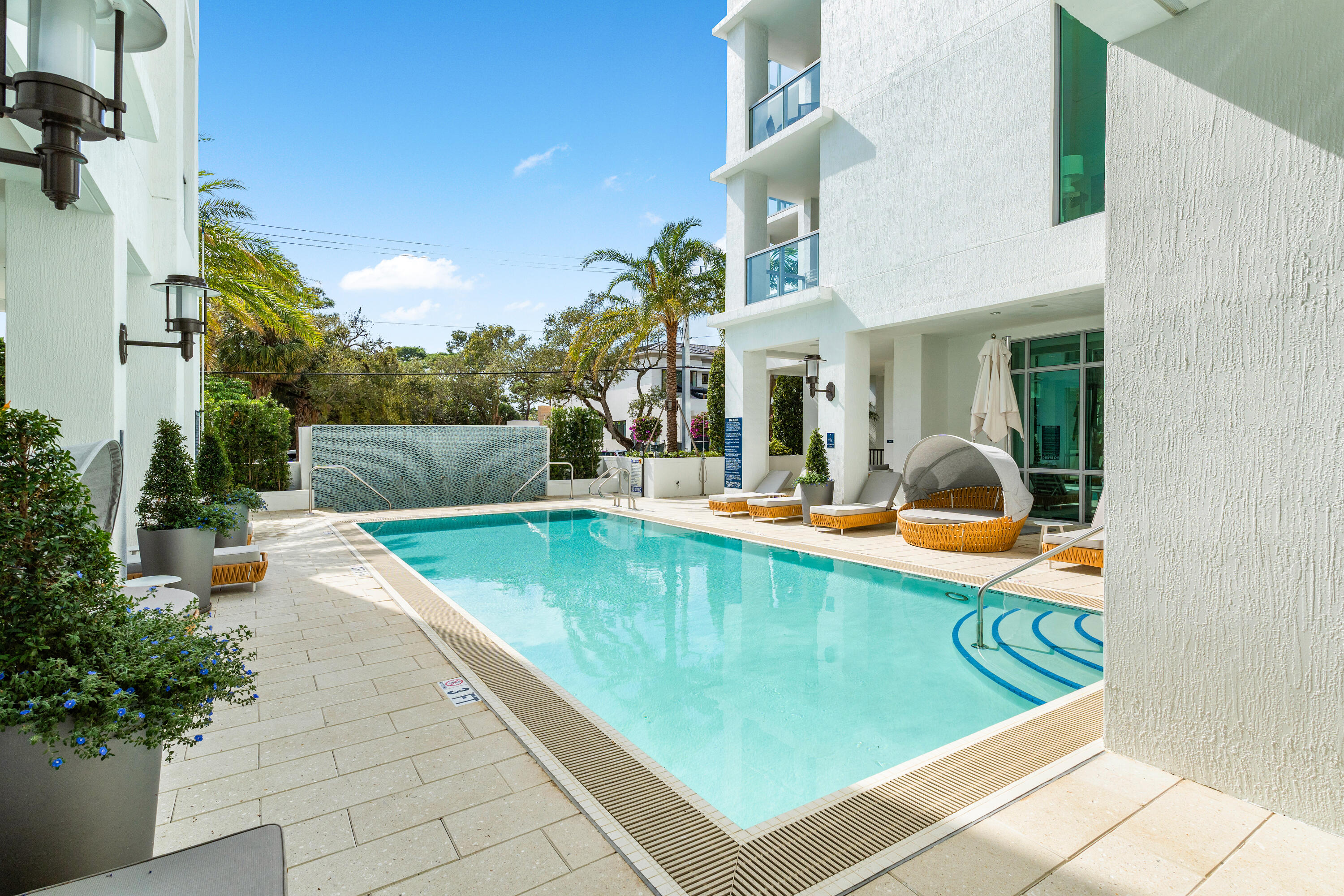 495 East Royal Palm Road, Unit 402 Boca Raton, FL 33432 - Photo 45 of 63 a view of a swimming pool with a lounge chairs