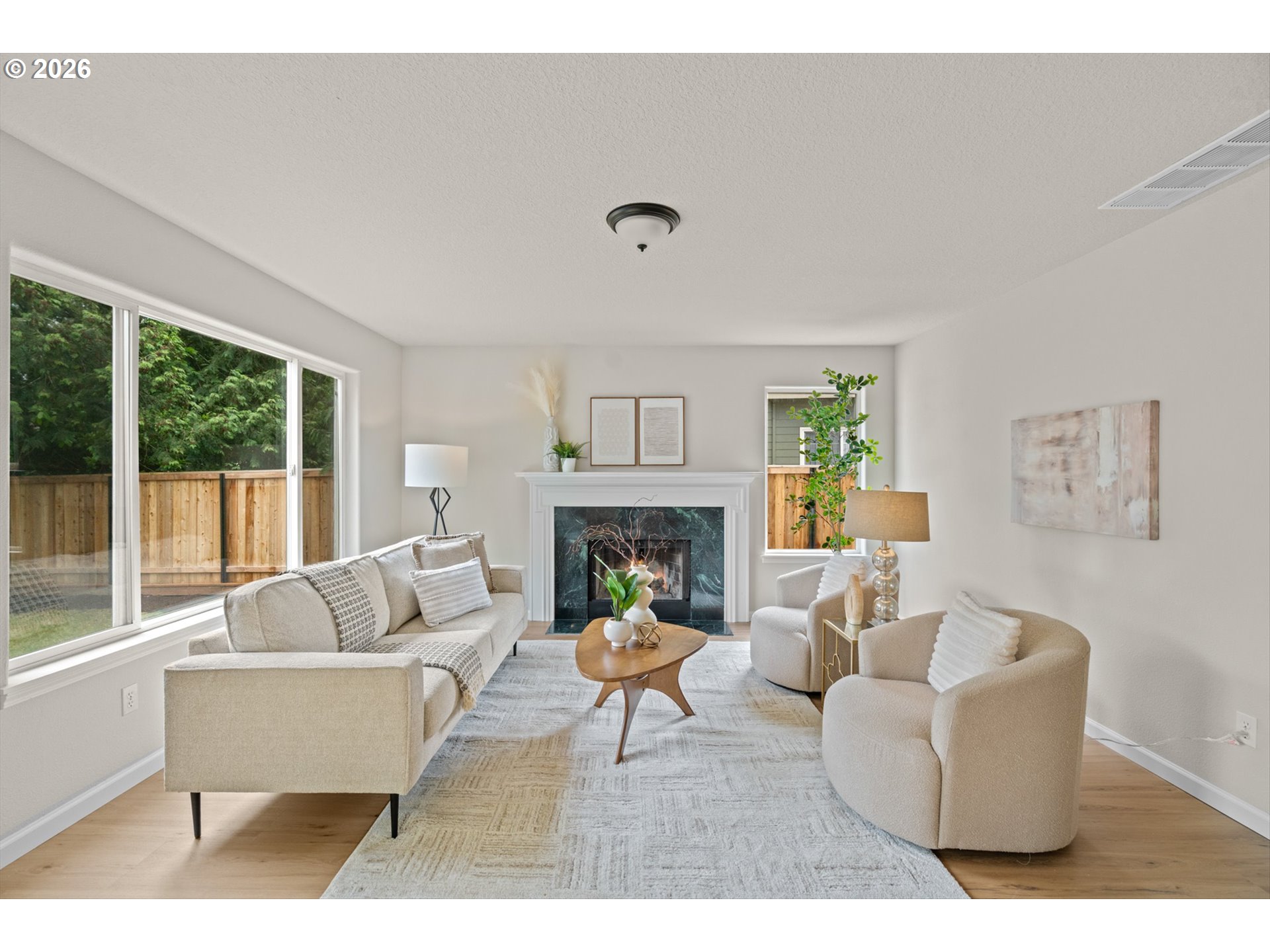 462 Southwest 211th Avenue Beaverton, OR 97006 - Photo 10 of 40 a living room with furniture a fireplace and a large window