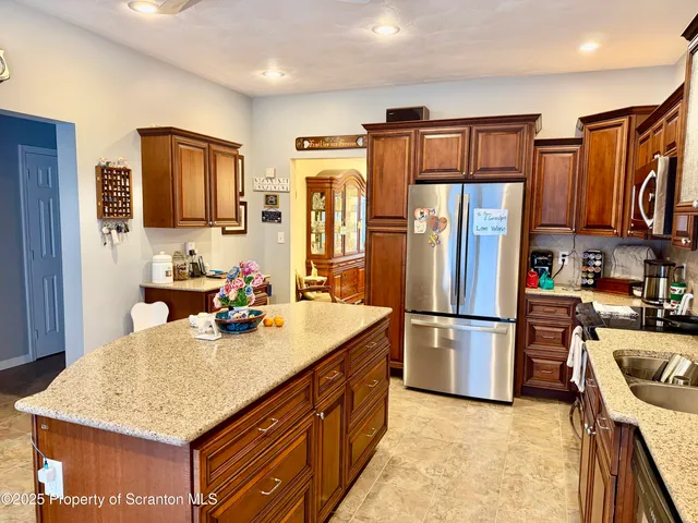 a kitchen with refrigerator and cabinets