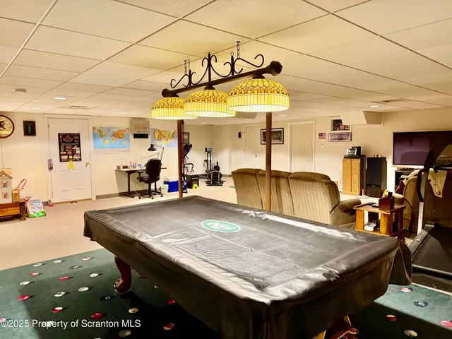 a dining hall with a table and chairs in it
