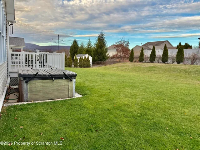 a view of house with garden and deck