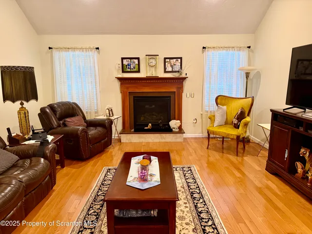 a living room with furniture fireplace and flat screen tv