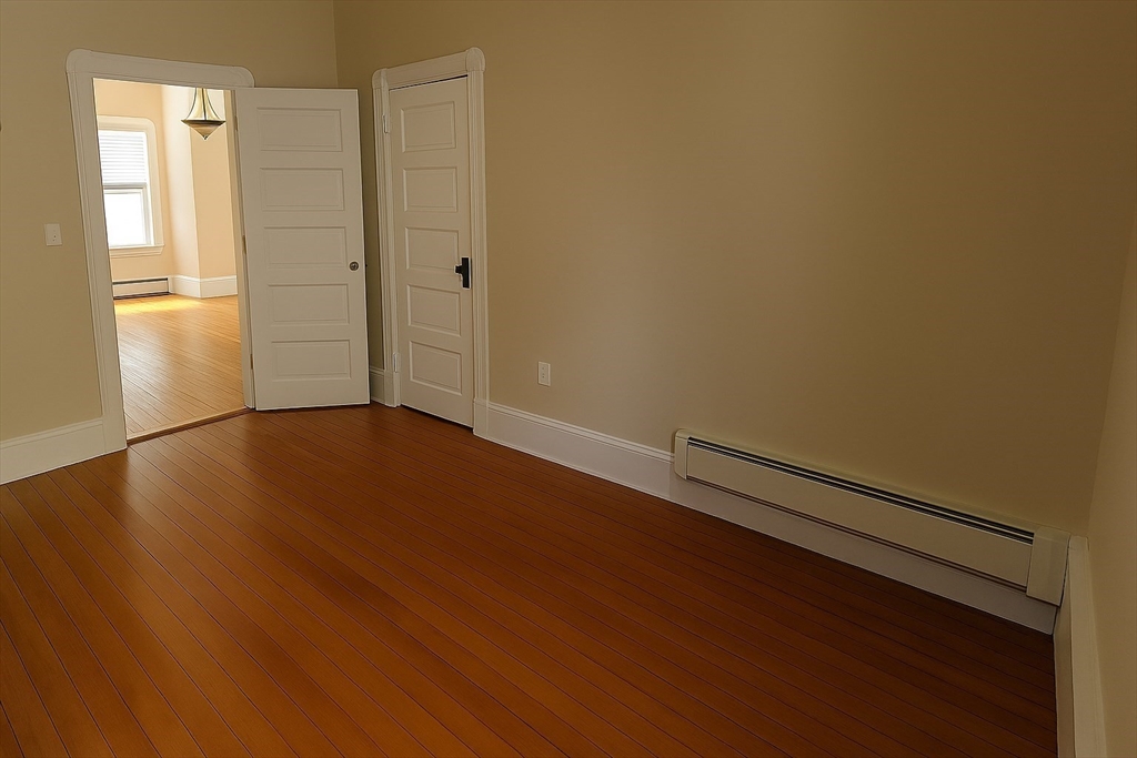 105 6th Street, Unit 1 Fall River, MA 02721 - Photo 2 of 8 a view of an empty room with wooden floor and a window
