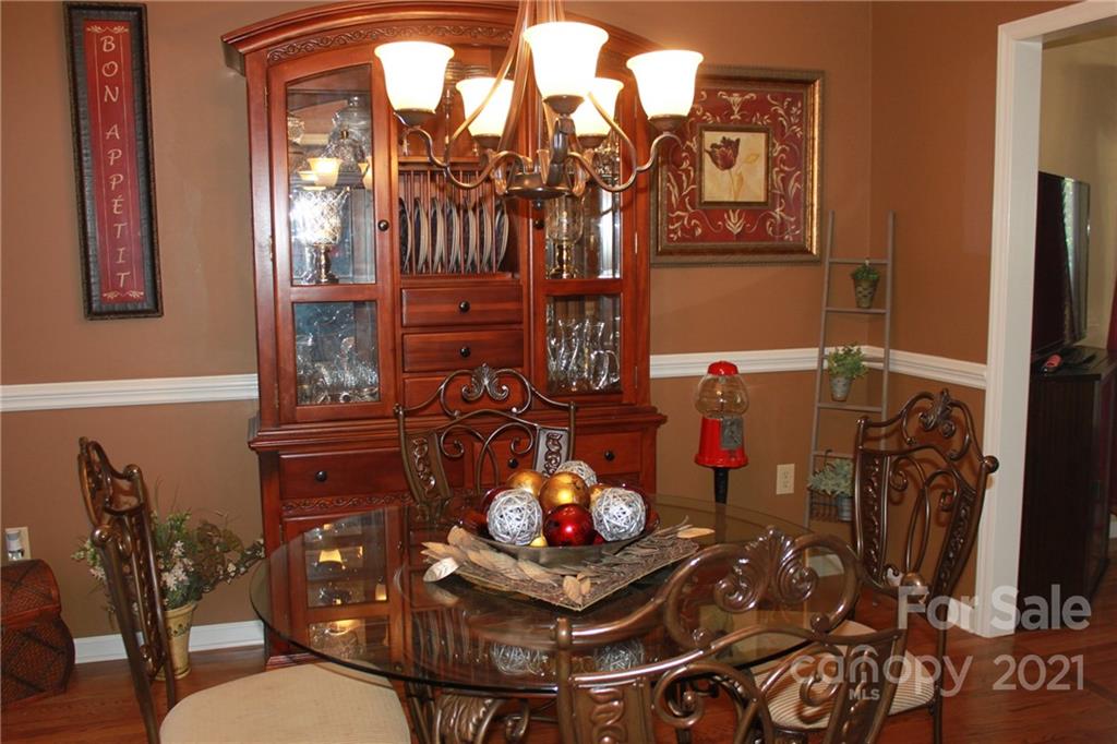 128 Cameron Drive Rutherfordton, NC 28139 - Photo 11 of 48 a living room with furniture a chandelier and a fireplace