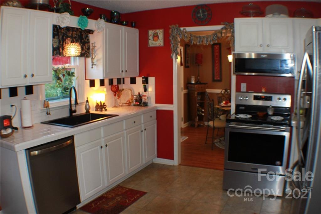 128 Cameron Drive Rutherfordton, NC 28139 - Photo 12 of 48 a kitchen with stainless steel appliances granite countertop a stove a sink and a microwave