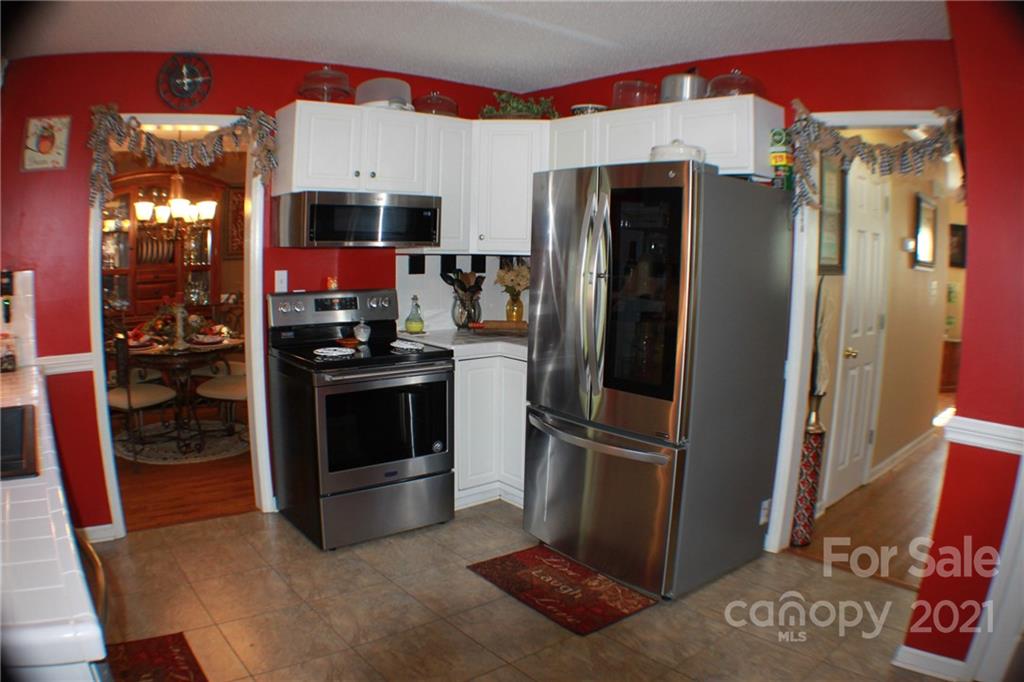 128 Cameron Drive Rutherfordton, NC 28139 - Photo 14 of 48 a kitchen with stainless steel appliances granite countertop a refrigerator and a stove