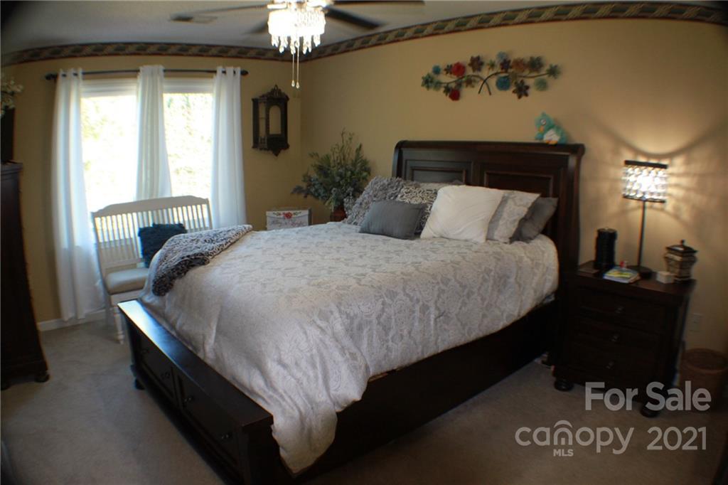 128 Cameron Drive Rutherfordton, NC 28139 - Photo 18 of 48 a bed sitting in a bedroom next to a window