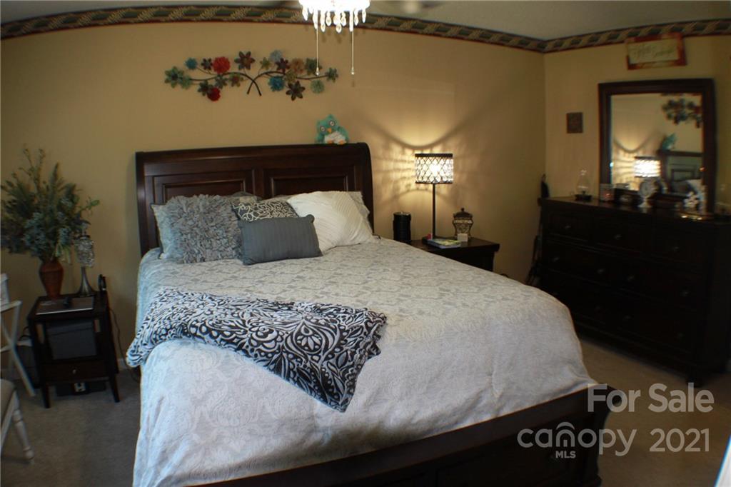 128 Cameron Drive Rutherfordton, NC 28139 - Photo 19 of 48 a bedroom with a bed and a mirror on dresser