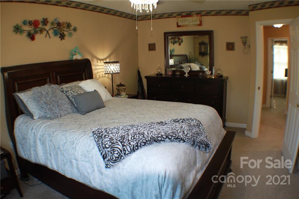 128 Cameron Drive Rutherfordton, NC 28139 - Photo 20 of 48 a bedroom with a large bed and a painting on the wall
