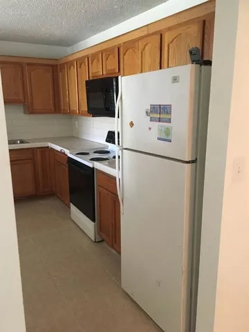a white refrigerator freezer sitting in a kitchen