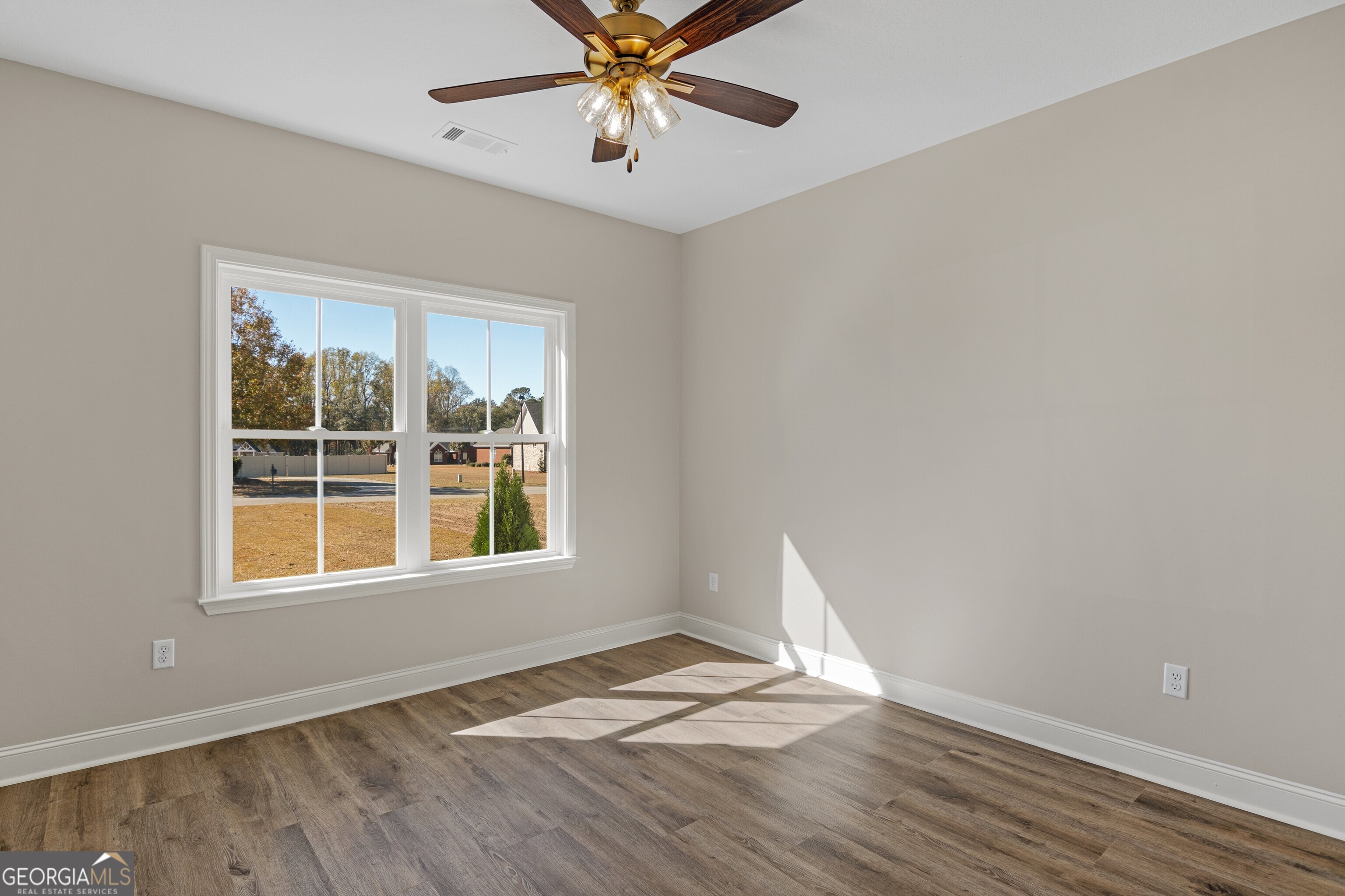 7 Honeysuckle Way Claxton, GA 30417 - Photo 20 of 31 a view of an empty room with wooden floor and a window