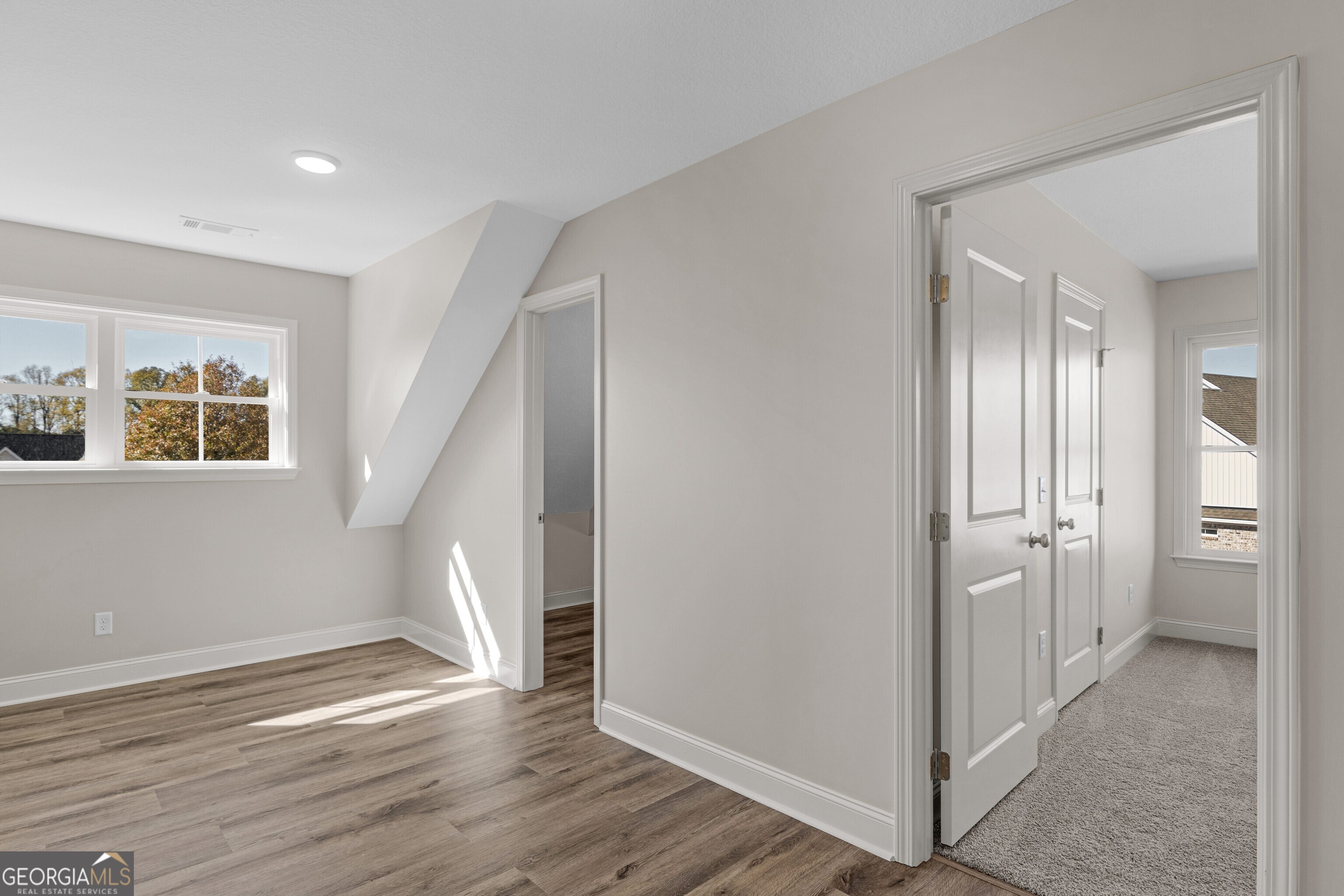 7 Honeysuckle Way Claxton, GA 30417 - Photo 22 of 31 a view of an empty room with wooden floor and a bathroom