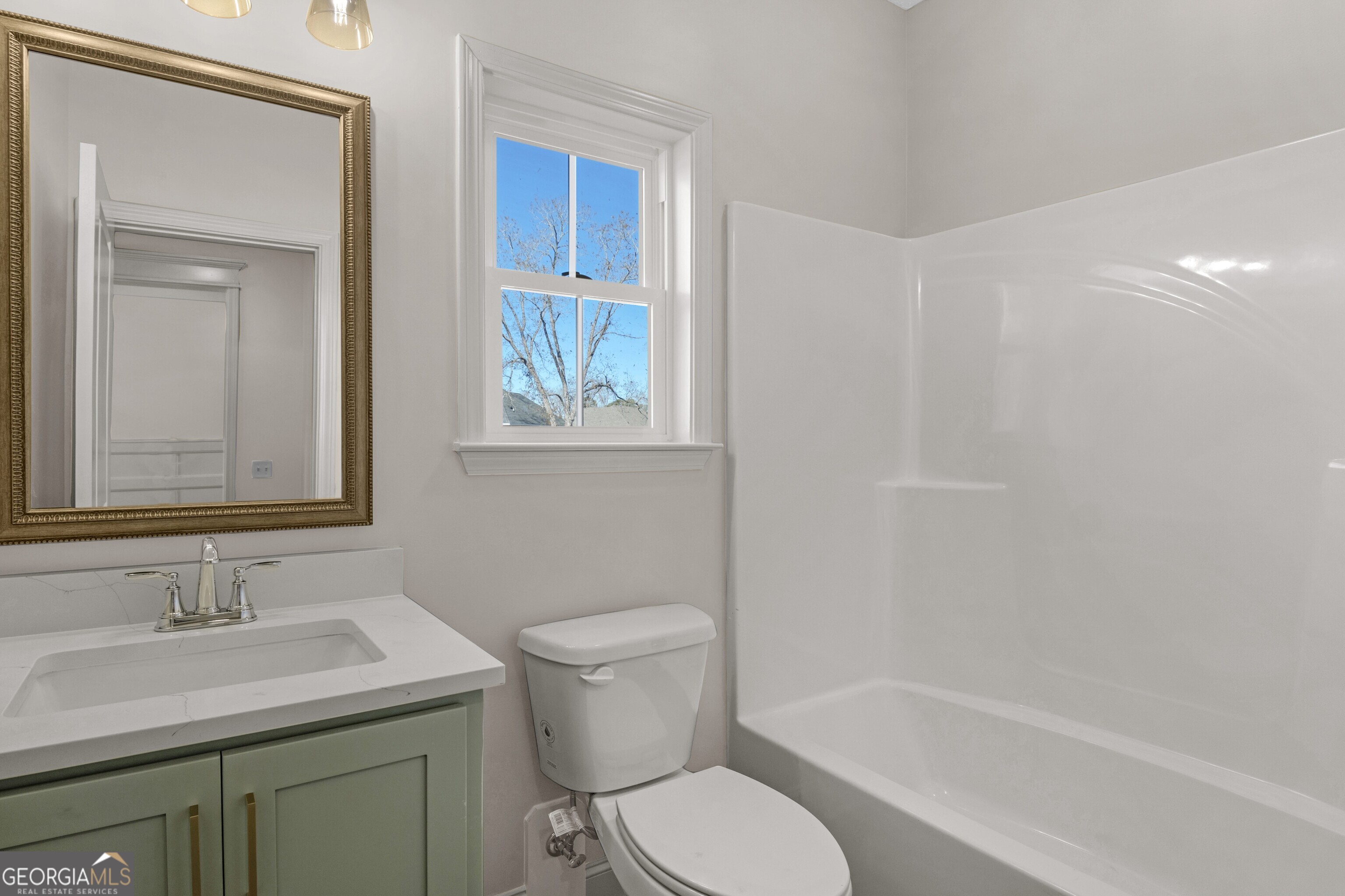 7 Honeysuckle Way Claxton, GA 30417 - Photo 25 of 31 a bathroom with a sink toilet vanity and tub