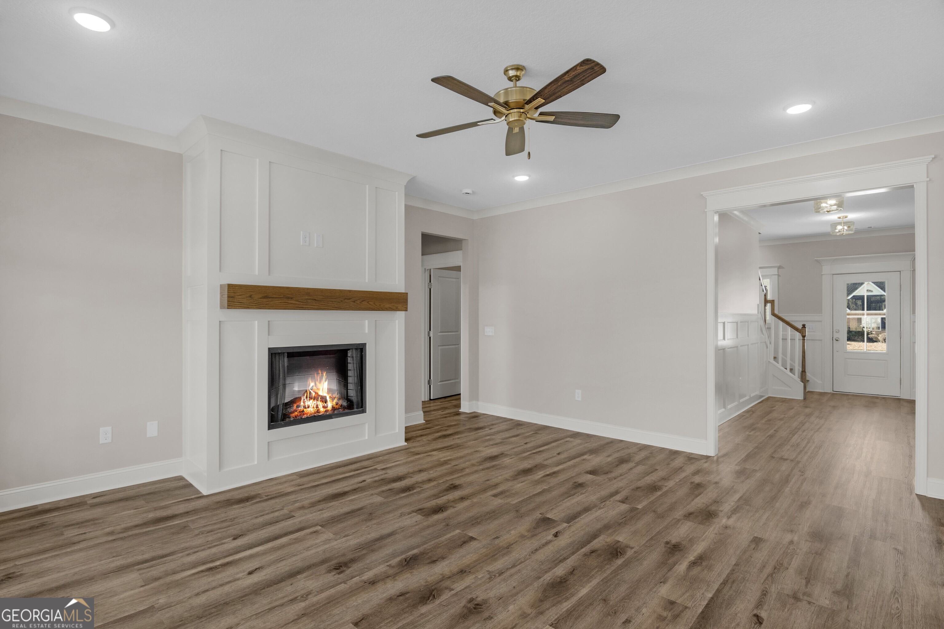 7 Honeysuckle Way Claxton, GA 30417 - Photo 5 of 31 a view of a livingroom with a fireplace a ceiling fan and wooden floor