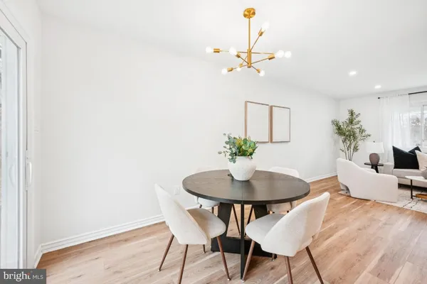 a dining room with furniture and wooden floor