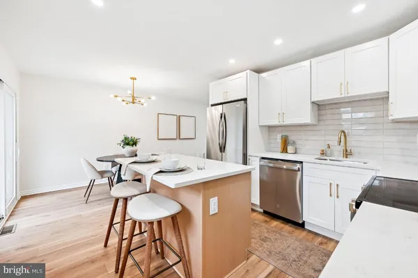 a kitchen with stainless steel appliances kitchen island granite countertop a sink and cabinets