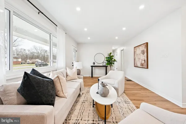 a living room with furniture and a large window