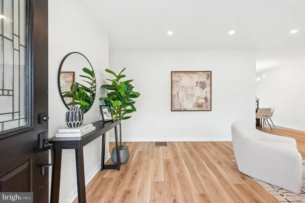 a picture of a living room with a potted plant