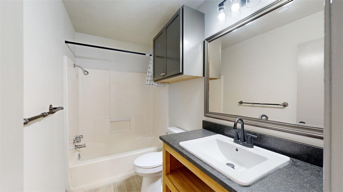 725 Peppertree Drive, Unit 26 Bryan, TX 77801 - Photo 9 of 14 Full bathroom with vanity, shower / tub combination, and toilet