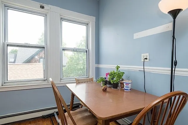 a view of a dining room with furniture window and wooden floor