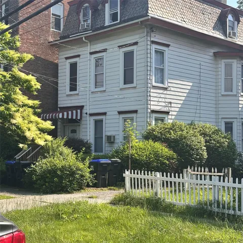 a front view of house and yard with green space