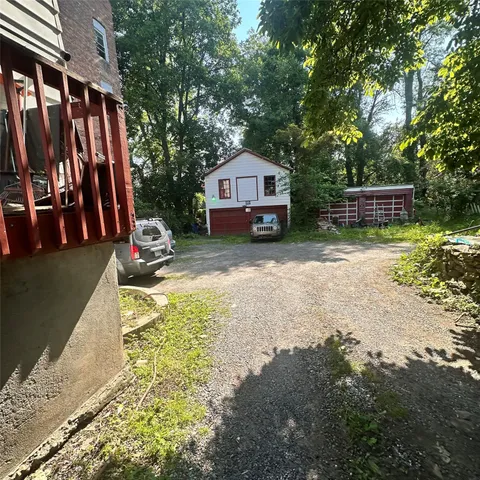 a car parked in front of a house with a small yard