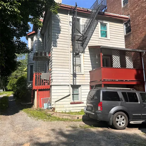 a front view of a house with parking space