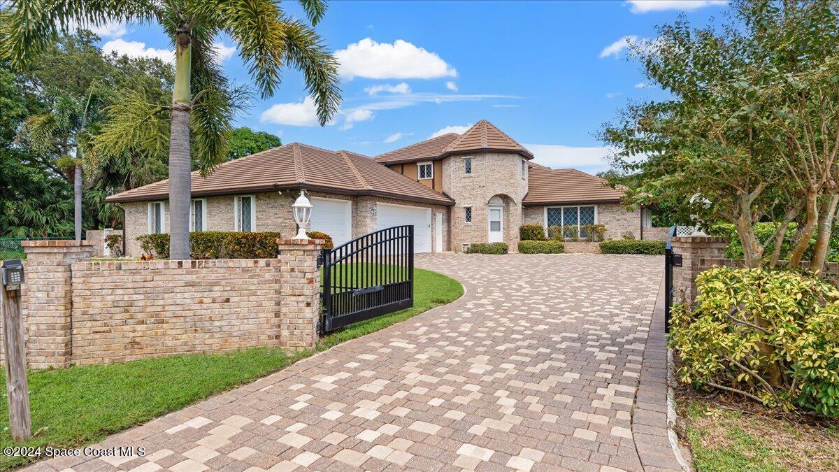 9140 South Tropical Trail Merritt Island, FL 32952 - Photo 12 of 68 a front view of a house with garden