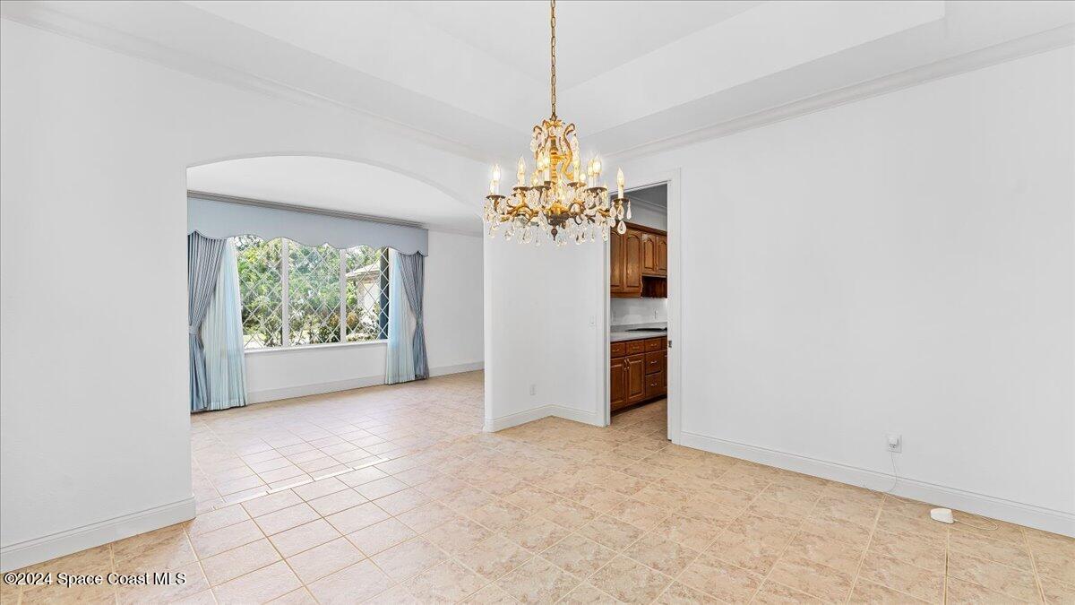 9140 South Tropical Trail Merritt Island, FL 32952 - Photo 16 of 68 a view of a chandelier in big room and chandelier