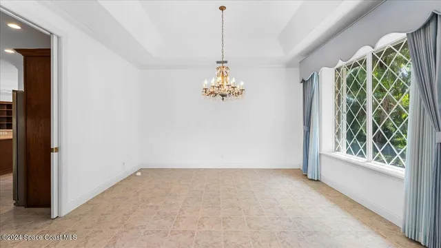 a view of an empty room with a fireplace and a window