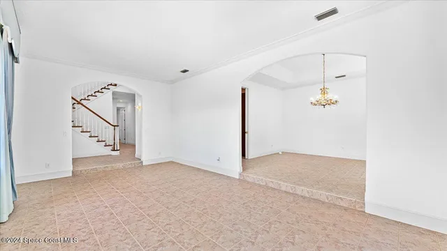 an empty room with windows and outdoor view