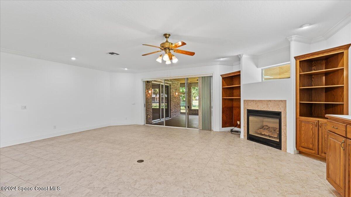 9140 South Tropical Trail Merritt Island, FL 32952 - Photo 23 of 68 a view of an empty room with a fireplace and a window