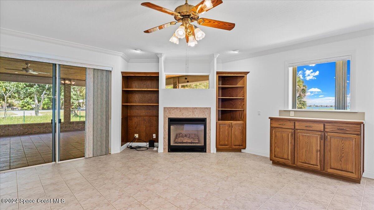 9140 South Tropical Trail Merritt Island, FL 32952 - Photo 24 of 68 a view of an empty room with a fireplace and a window
