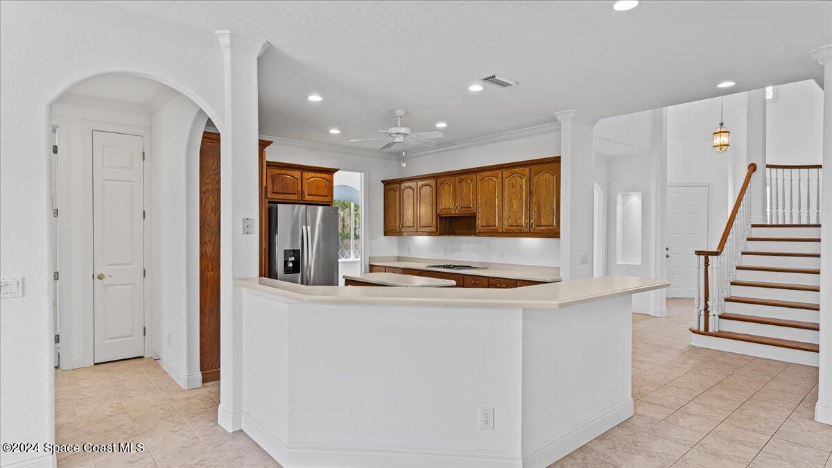 9140 South Tropical Trail Merritt Island, FL 32952 - Photo 26 of 68 a kitchen with stainless steel appliances granite countertop a refrigerator and a stove