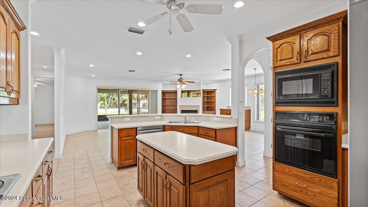 9140 South Tropical Trail Merritt Island, FL 32952 - Photo 29 of 68 a kitchen with a sink stove and refrigerator