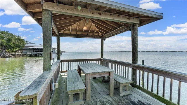 a view of balcony with wooden floor and outdoor seating