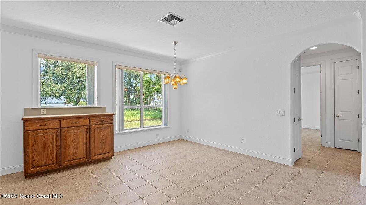 9140 South Tropical Trail Merritt Island, FL 32952 - Photo 33 of 68 a view of an empty room with window cabinet and fire place