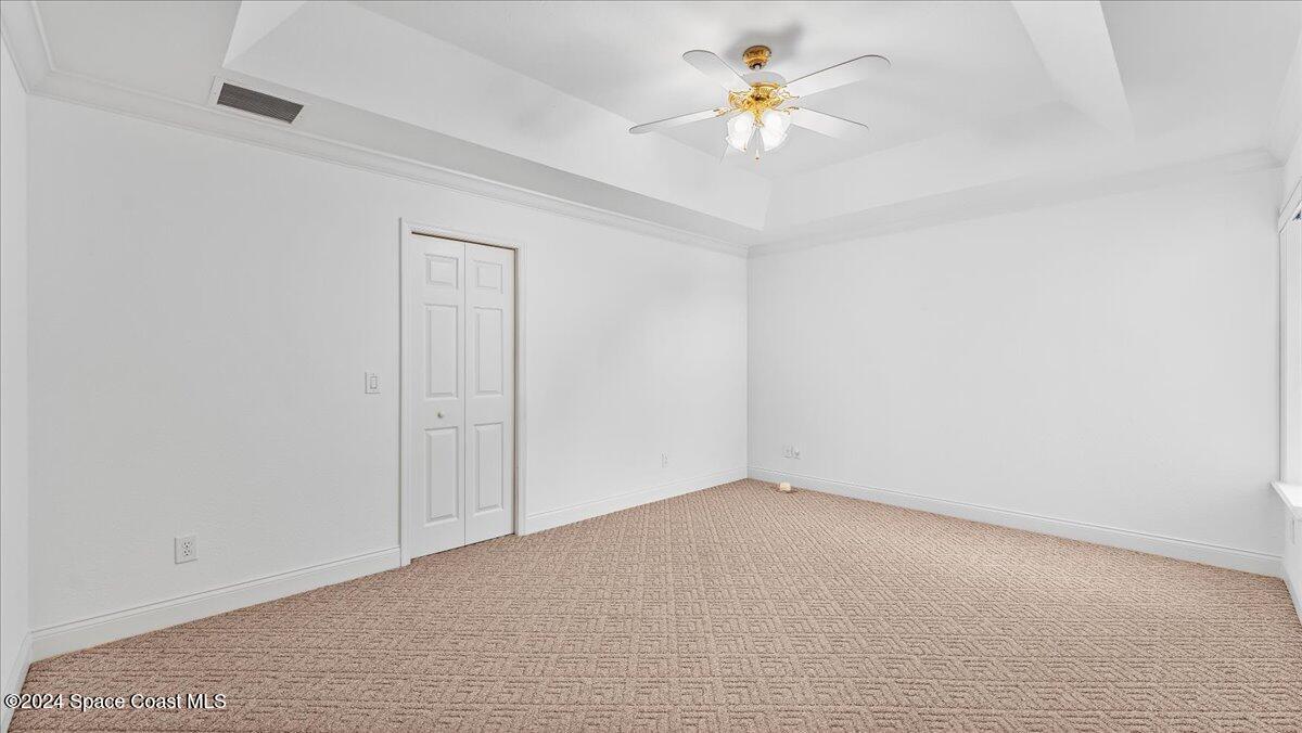 9140 South Tropical Trail Merritt Island, FL 32952 - Photo 39 of 68 an empty room with a window and a ceiling fan