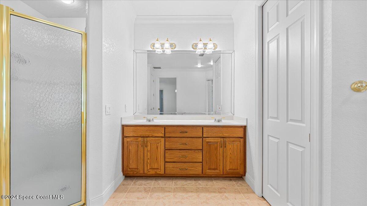 9140 South Tropical Trail Merritt Island, FL 32952 - Photo 44 of 68 a bathroom with a sink and a mirror