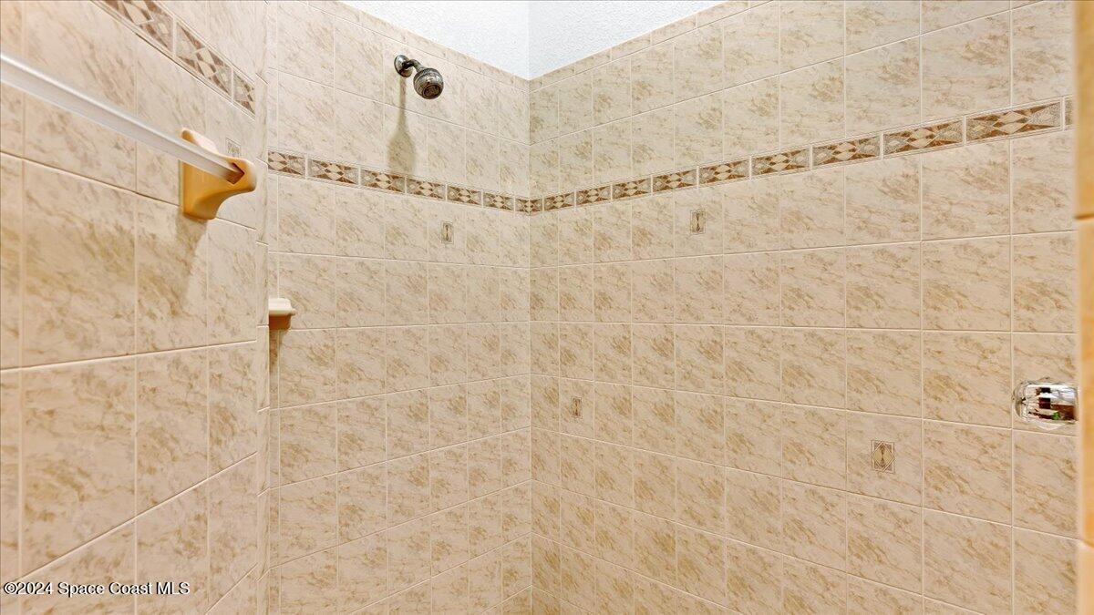 9140 South Tropical Trail Merritt Island, FL 32952 - Photo 45 of 68 a bathroom with a shower