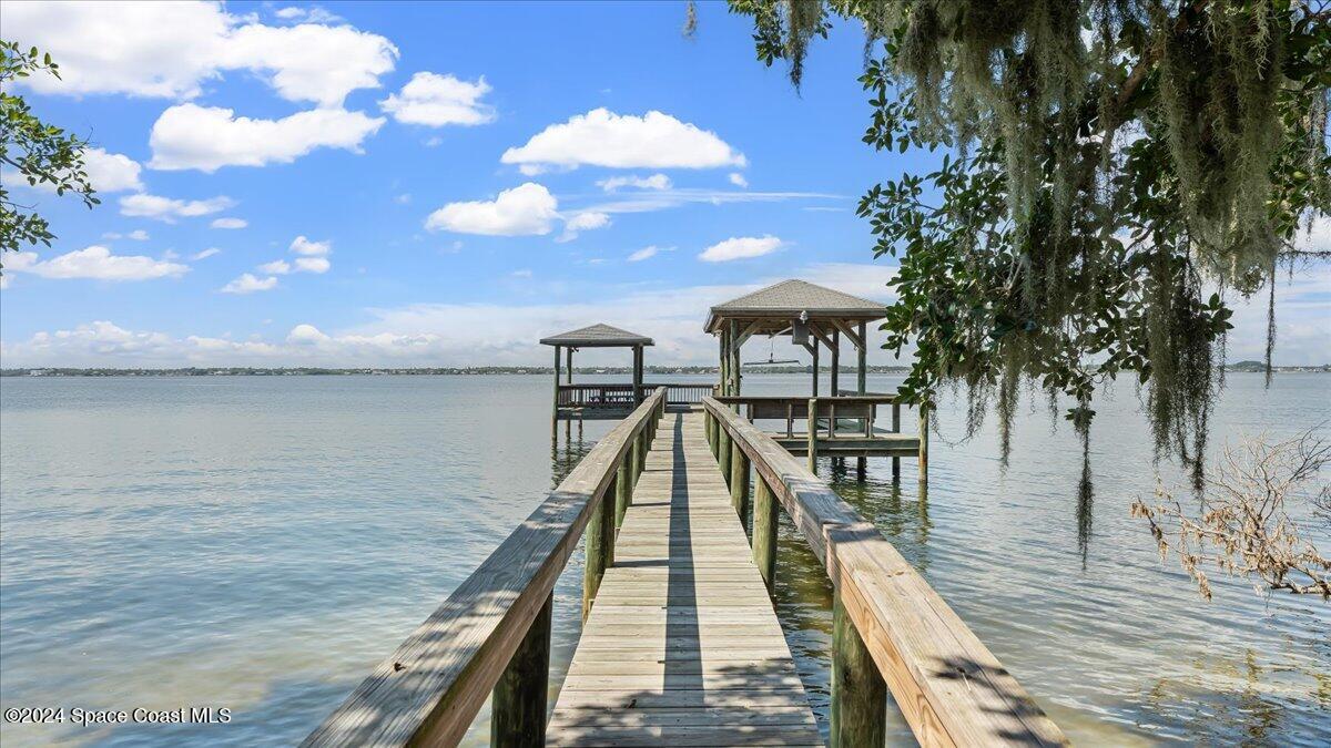 9140 South Tropical Trail Merritt Island, FL 32952 - Photo 62 of 68 a view of a lake with a table and chairs
